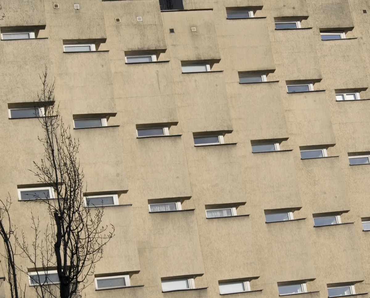 Narrow slit windows on a blank beige wall
